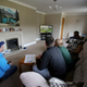 A family watches a computer generated 'Virtual Grand National.